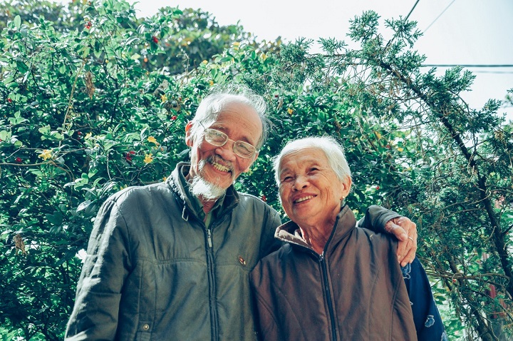 old couple infront of their garden